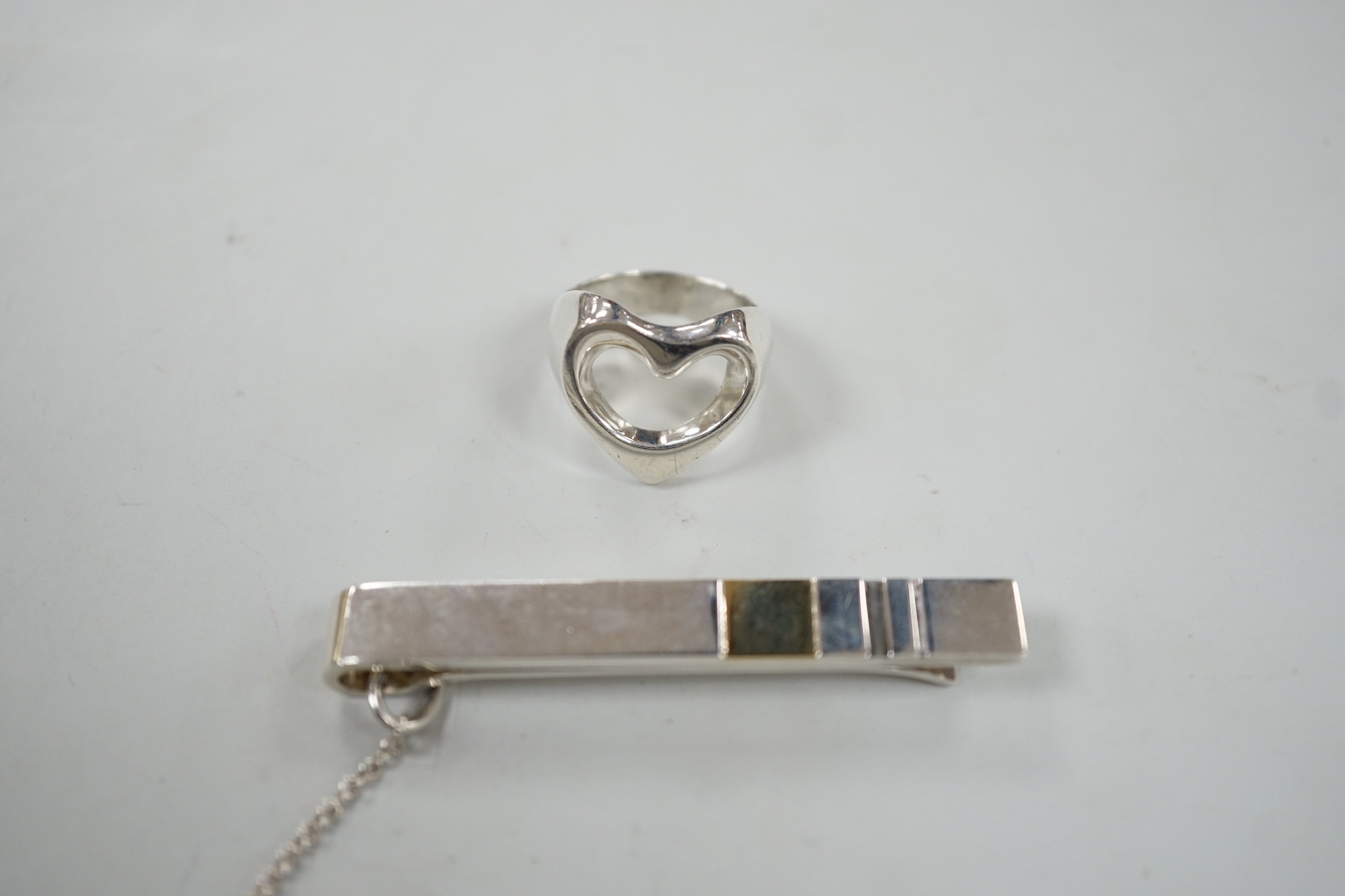 A Georg Jensen sterling pierced heart ring, size N and a Georg Jensen two colour sterling tie clip, design no. 152A, 58mm.